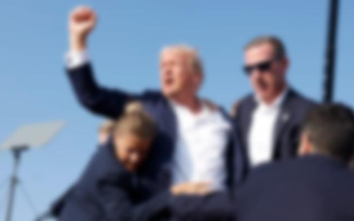 Blurred image of Donald Trump after taking an assassin's bullet. It is blurred to obscure the photo on Facebook, that seems to censor all things about Trump.