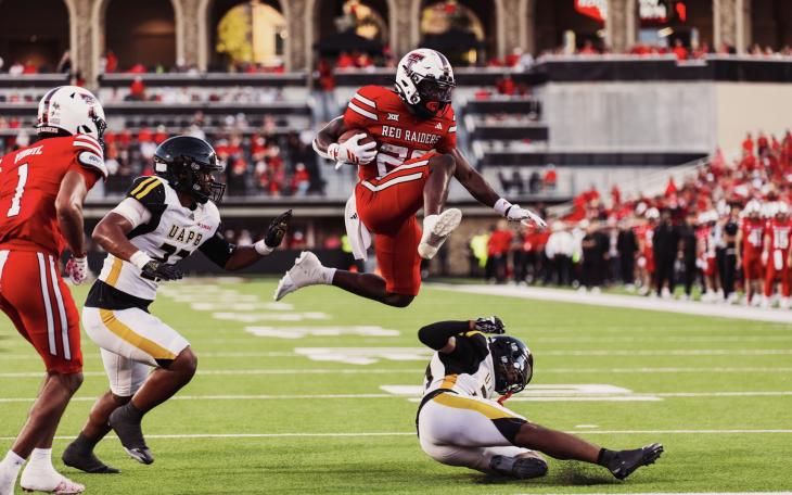 Texas Tech's J'Koby Williams hurdles a defender on his way to a touchdown.