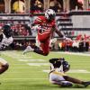 Texas Tech's J'Koby Williams hurdles a defender on his way to a touchdown.